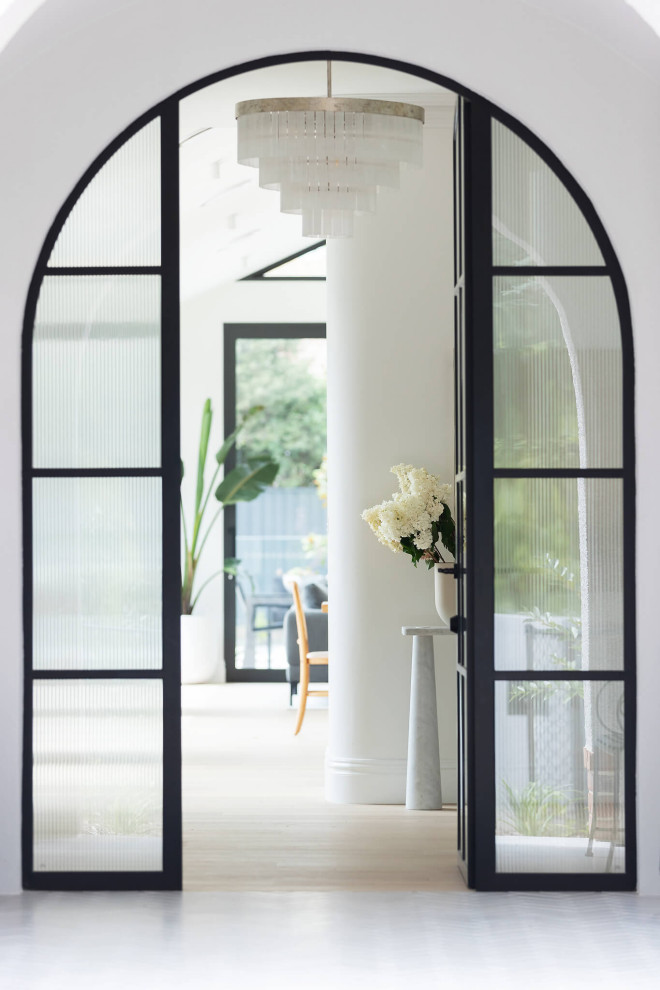 Inspiration for a contemporary foyer in Canberra - Queanbeyan with white walls, light hardwood flooring, a single front door and a glass front door.