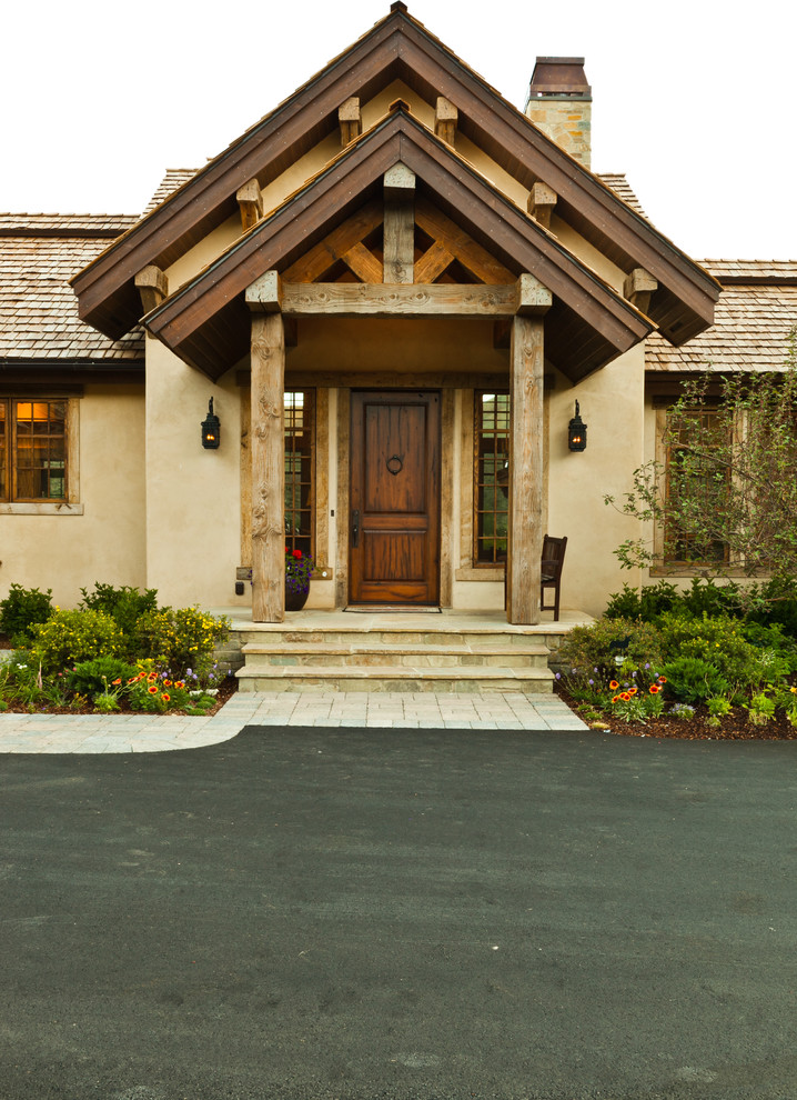 This is an example of a country entryway in Boise with a single front door and a dark wood front door.
