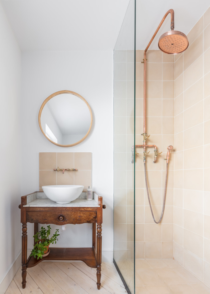 Inspiration for a transitional 3/4 bathroom in London with medium wood cabinets, a corner shower, beige tile, white walls, light hardwood floors, a vessel sink, marble benchtops, beige floor, an open shower and white benchtops.