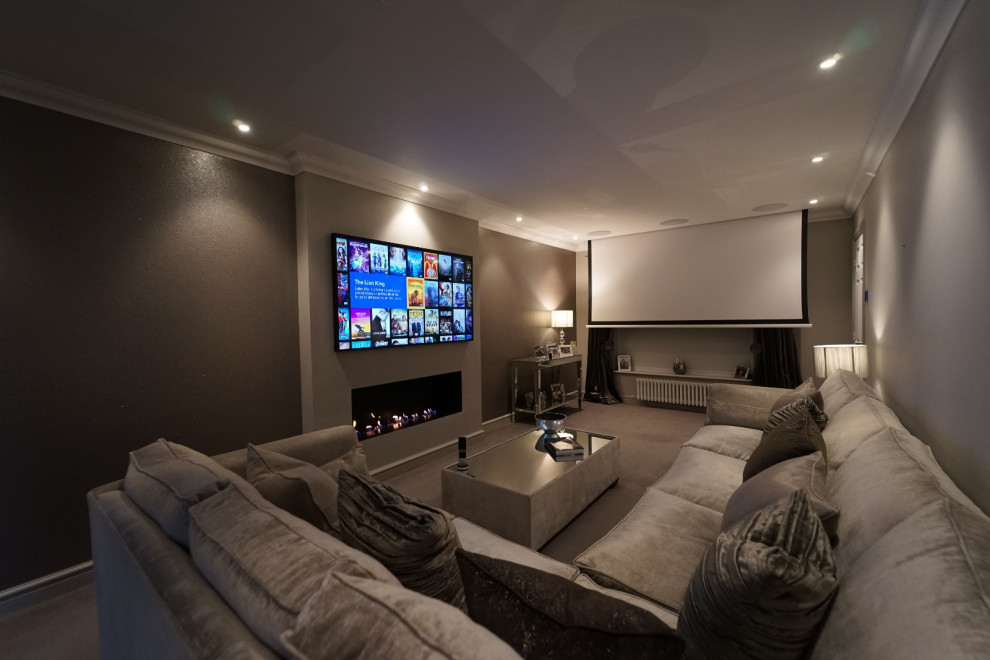 Mid-sized minimalist enclosed carpeted and gray floor home theater photo in Other with gray walls and a projector screen