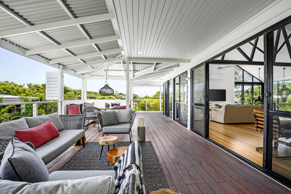 Large beach style deck in Sunshine Coast with a roof extension.