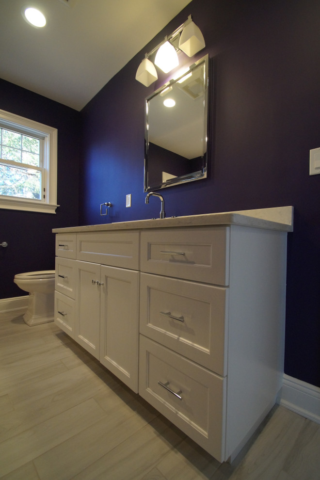 Mid-sized traditional bathroom in Other with shaker cabinets, white cabinets, an alcove tub, a shower/bathtub combo, a two-piece toilet, purple walls, porcelain floors, an undermount sink, engineered quartz benchtops, grey floor, white benchtops, a single vanity and a freestanding vanity.