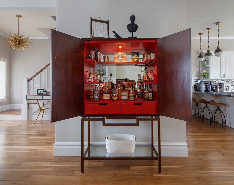 Transitional home bar in San Francisco with red cabinets and medium hardwood floors.