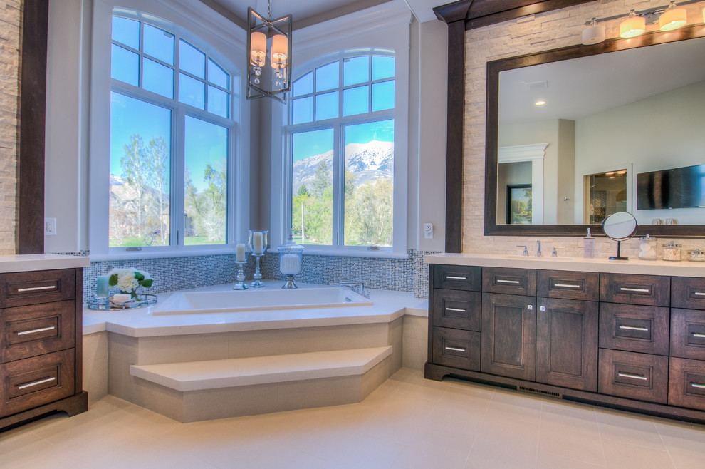 Inspiration for a large traditional master bathroom in Salt Lake City with an undermount sink, recessed-panel cabinets, dark wood cabinets, quartzite benchtops, a drop-in tub, an alcove shower, a one-piece toilet, ceramic tile, grey walls and ceramic floors.
