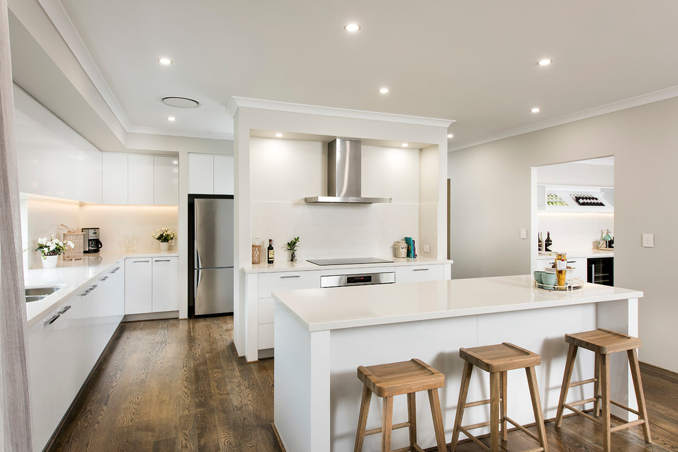 Large modern galley kitchen pantry in Perth with a double-bowl sink, flat-panel cabinets, white cabinets, quartzite benchtops, white splashback, glass sheet splashback, stainless steel appliances, vinyl floors and with island.