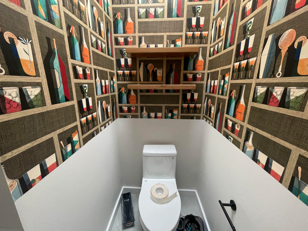 Photo of a small scandinavian cloakroom in Seattle with flat-panel cabinets, brown cabinets, a one-piece toilet, grey walls, porcelain flooring, an integrated sink, solid surface worktops, grey floors, white worktops, a floating vanity unit and wallpapered walls.