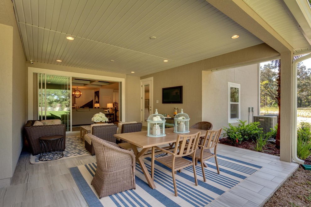 Mid-sized traditional side yard patio in Jacksonville with tile and a roof extension.