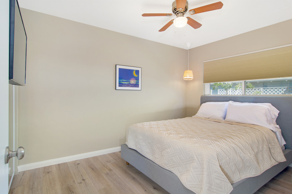 Design ideas for a mid-sized contemporary master bedroom in San Diego with green walls, linoleum floors and multi-coloured floor.