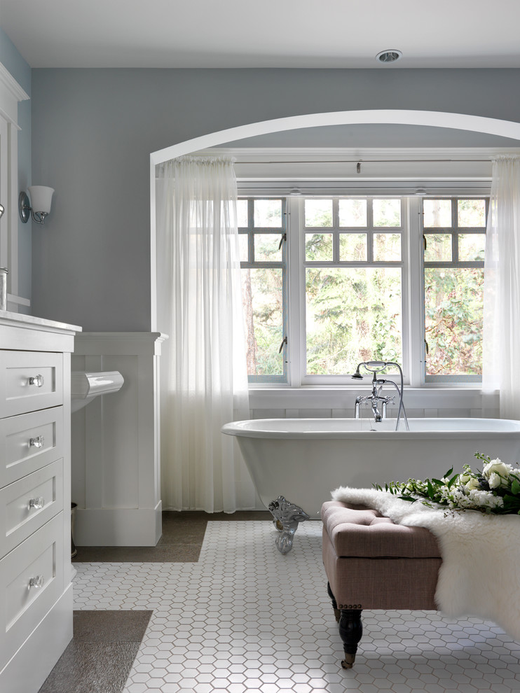 Design ideas for a large traditional master bathroom in Other with shaker cabinets, white cabinets, a claw-foot tub, grey walls, a pedestal sink, ceramic floors and white floor.