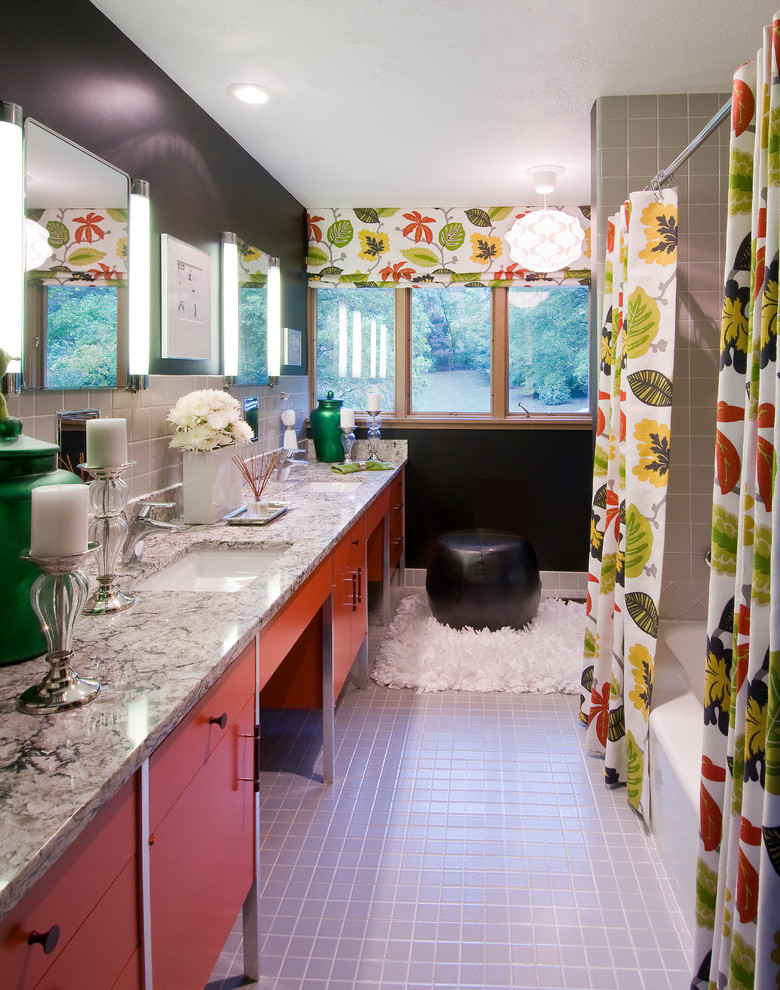 Inspiration for a mid-sized midcentury kids bathroom in St Louis with an undermount sink, flat-panel cabinets, red cabinets, engineered quartz benchtops, a drop-in tub, a shower/bathtub combo, a two-piece toilet, gray tile, porcelain tile, black walls and porcelain floors.