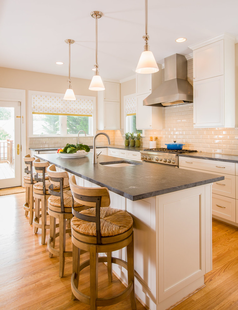 Traditional kitchen in DC Metro with an undermount sink, recessed-panel cabinets, white cabinets, white splashback, subway tile splashback, medium hardwood floors and with island.