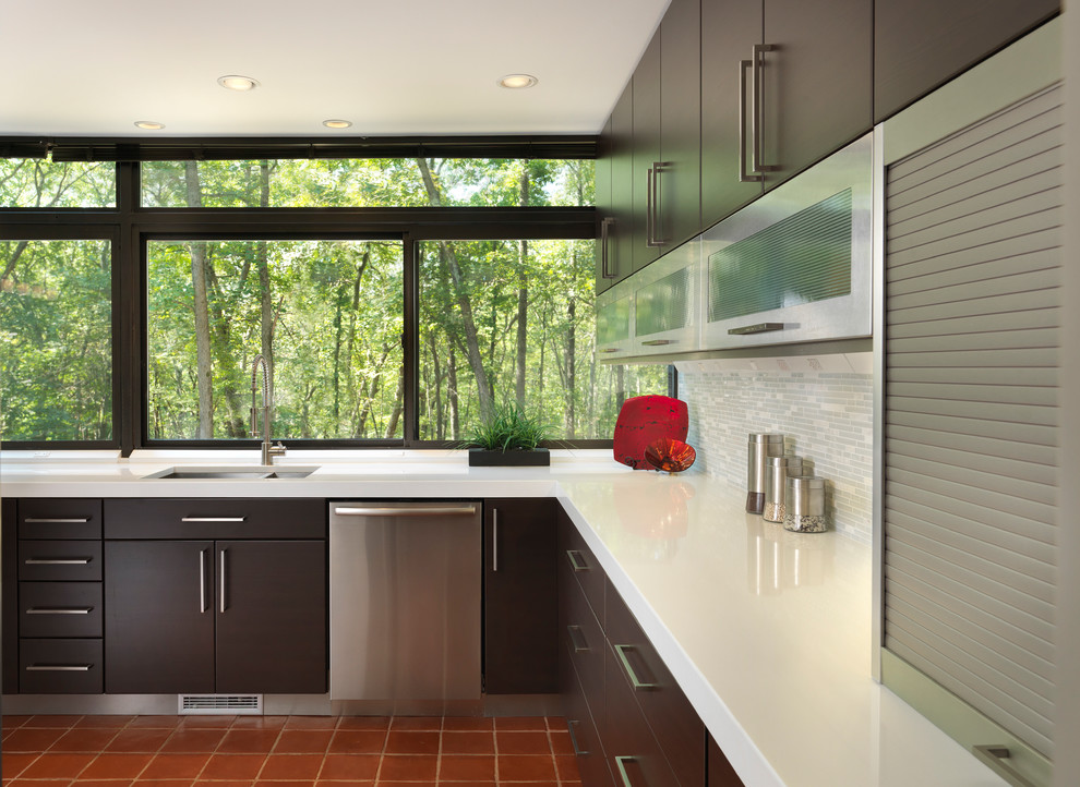 Example of a mid-sized minimalist l-shaped terra-cotta tile kitchen design in Providence with stainless steel appliances, an undermount sink, flat-panel cabinets, dark wood cabinets, quartz countertops, gray backsplash, matchstick tile backsplash and no island