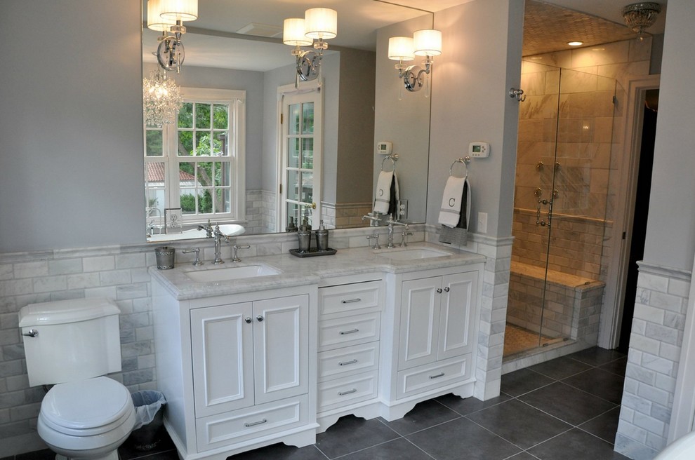 Inspiration for a traditional master bathroom in Minneapolis with beaded inset cabinets, white cabinets, a claw-foot tub, an alcove shower, a two-piece toilet, gray tile, marble, grey walls, ceramic floors, an undermount sink, marble benchtops, grey floor and a hinged shower door.