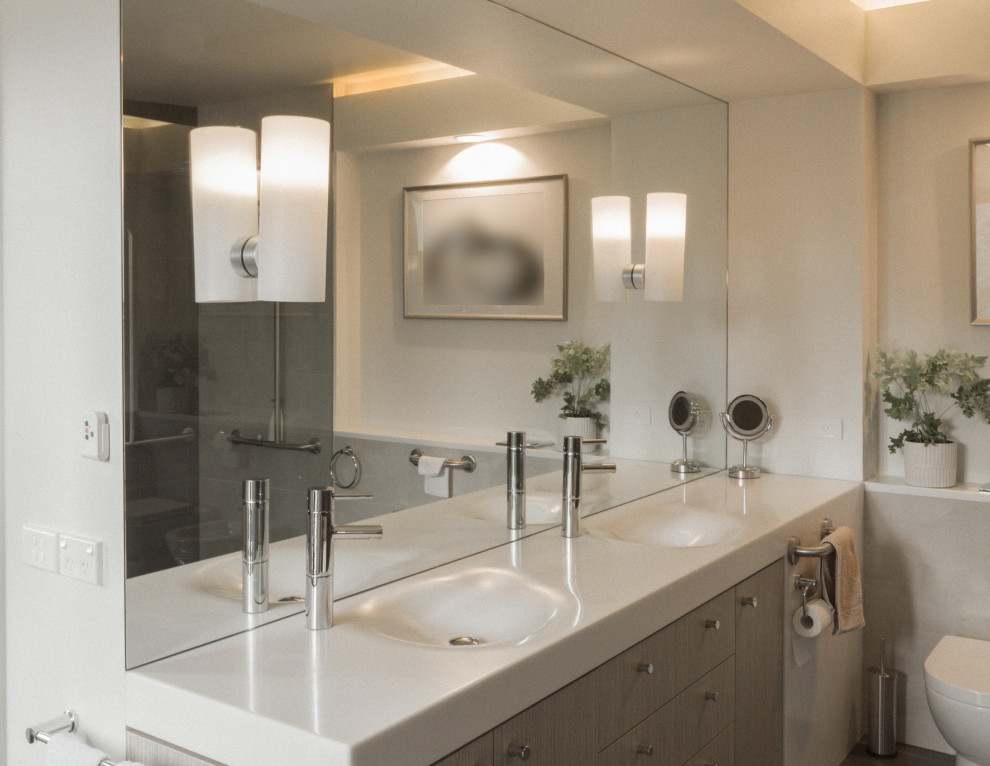 Inspiration for a large contemporary master bathroom in Melbourne with furniture-like cabinets, beige cabinets, a drop-in tub, a double shower, a bidet, beige tile, porcelain tile, white walls, porcelain floors, an integrated sink, solid surface benchtops, grey floor, an open shower, white benchtops, a double vanity, a built-in vanity and coffered.