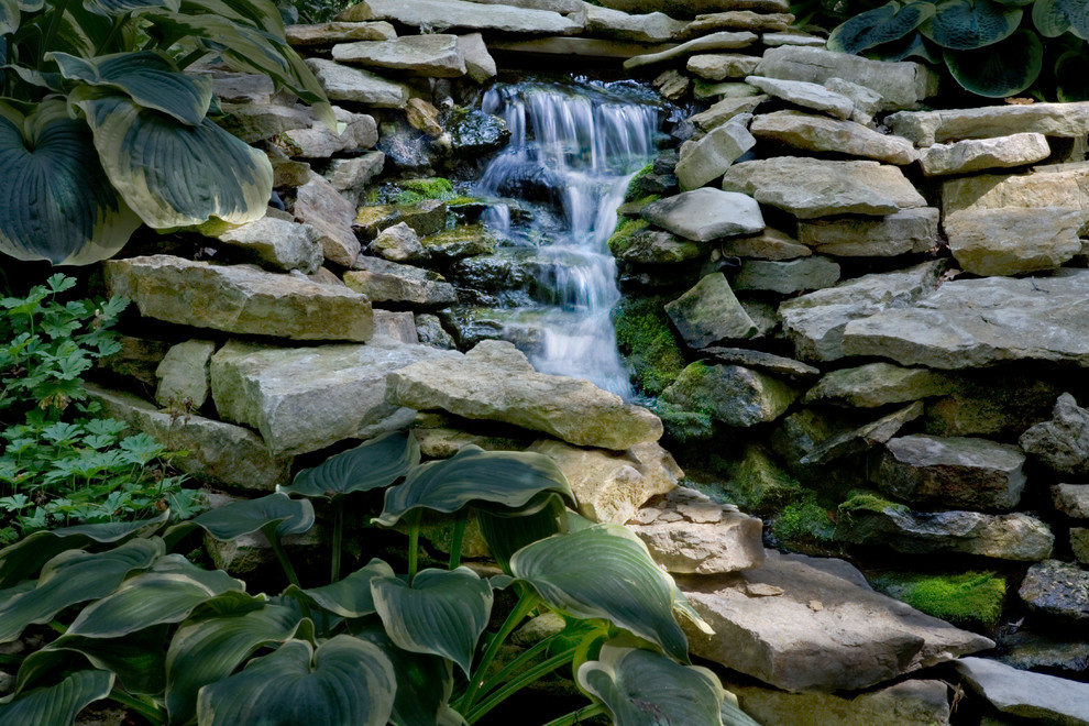 Photo of a mid-sized rustic shade side yard water fountain landscape for summer.