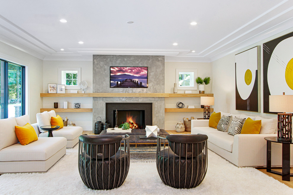 Mid-sized contemporary open concept family room in New York with white walls, light hardwood floors, a standard fireplace, a concrete fireplace surround, a wall-mounted tv, beige floor and coffered.