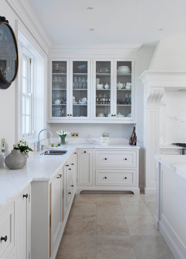 Inspiration for a large traditional u-shaped open plan kitchen in Other with a drop-in sink, beaded inset cabinets, white cabinets, marble benchtops, white splashback, marble splashback, stainless steel appliances, porcelain floors, with island, beige floor and yellow benchtop.
