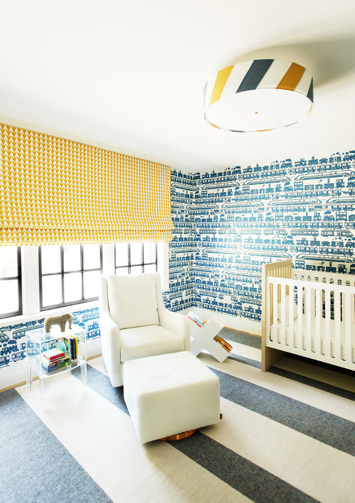 This is an example of a transitional gender-neutral nursery in Boston with blue walls, carpet and multi-coloured floor.