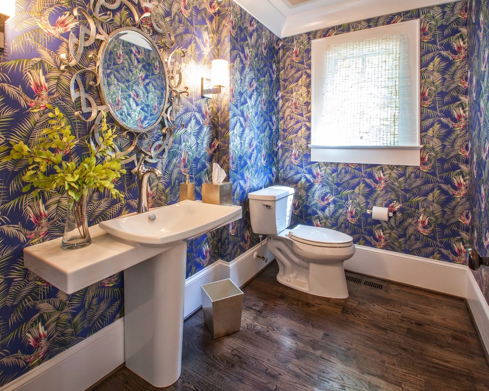 Photo of a mid-sized eclectic bathroom in Dublin with a one-piece toilet, dark hardwood floors and a pedestal sink.