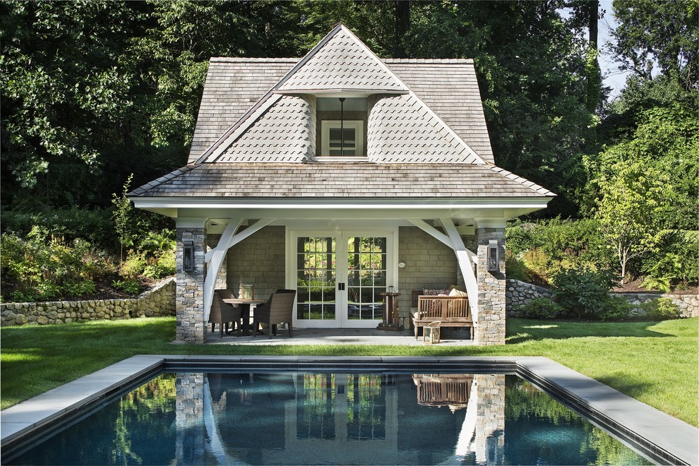 Traditional backyard rectangular pool in New York with a pool house.