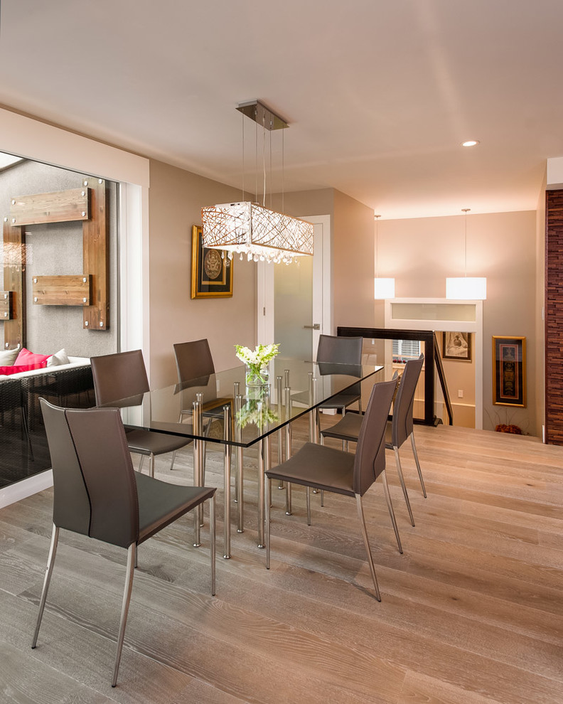 This is an example of a mid-sized contemporary open plan dining in Vancouver with grey walls, light hardwood floors and no fireplace.