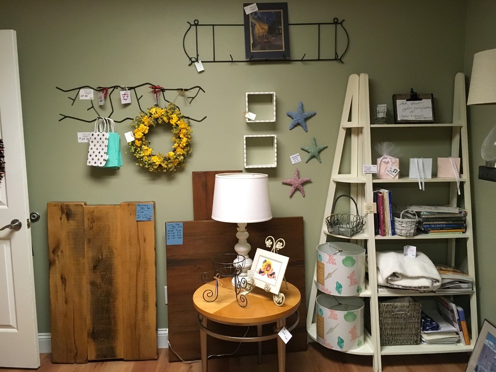 Photo of a small eclectic craft room in Raleigh with green walls and medium hardwood floors.