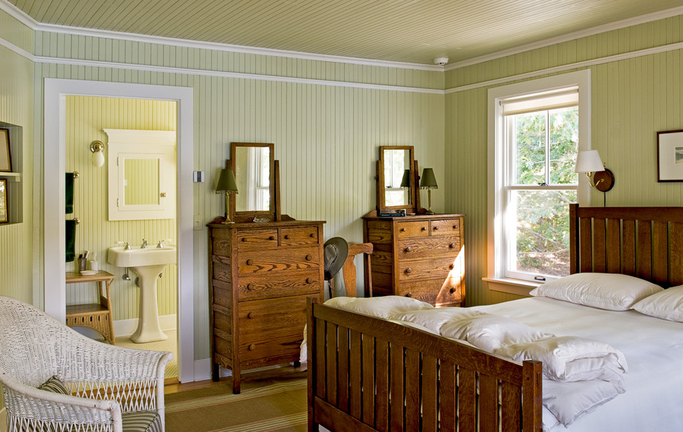 This is an example of a beach style bedroom in Portland Maine with green walls.