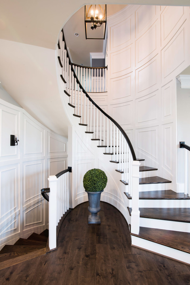 Traditional wood curved staircase in DC Metro with painted wood risers and wood railing.