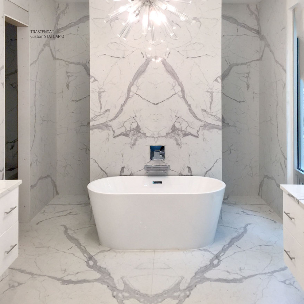 Large modern master bathroom in Miami with flat-panel cabinets, white cabinets, a freestanding tub, white tile, white walls, terrazzo floors, white benchtops and white floor.