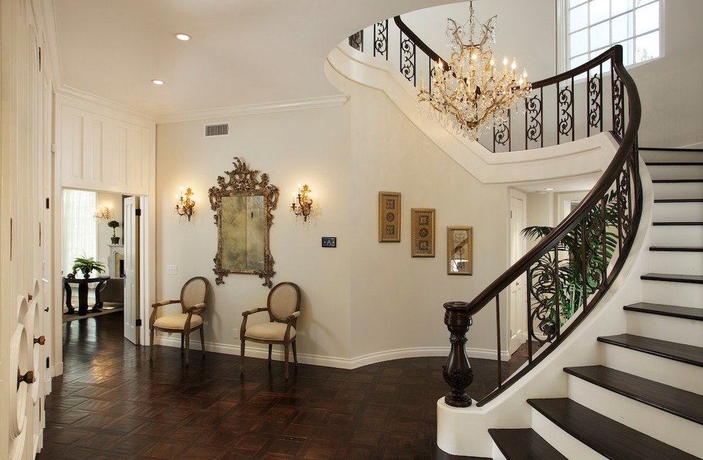 This is an example of a traditional foyer in Los Angeles with dark hardwood floors and brown floor.