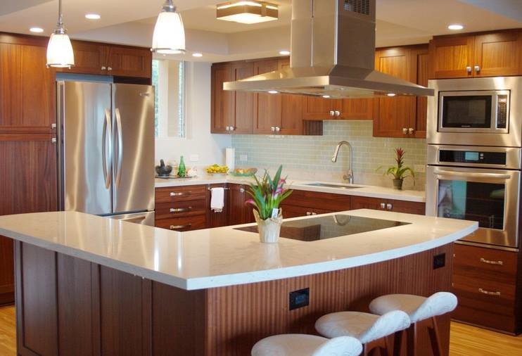 Large transitional l-shaped light wood floor eat-in kitchen photo in Houston with a drop-in sink, dark wood cabinets, marble countertops, blue backsplash, glass tile backsplash, stainless steel appliances and an island