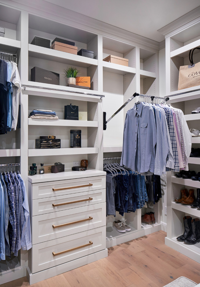Design ideas for an expansive transitional walk-in wardrobe in Austin with shaker cabinets, grey cabinets, light hardwood floors and brown floor.