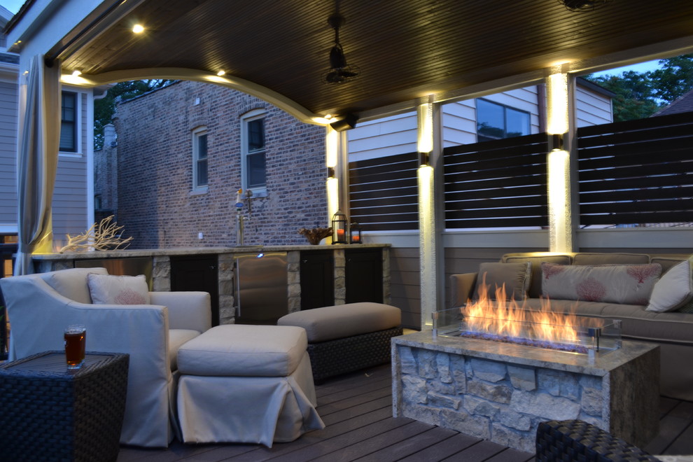 Photo of a mid-sized traditional rooftop deck in Chicago with a fire feature and a roof extension.