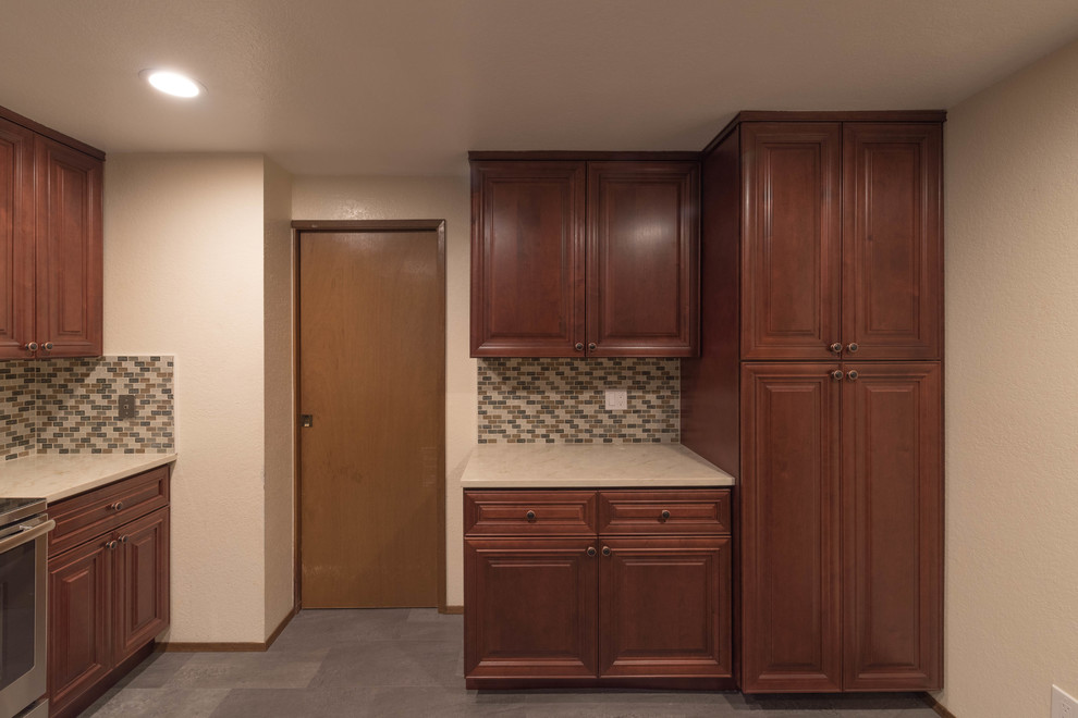 Enclosed kitchen - mid-sized transitional u-shaped ceramic tile and gray floor enclosed kitchen idea in Seattle with an undermount sink, beaded inset cabinets, dark wood cabinets, quartz countertops, multicolored backsplash, ceramic backsplash, stainless steel appliances and no island