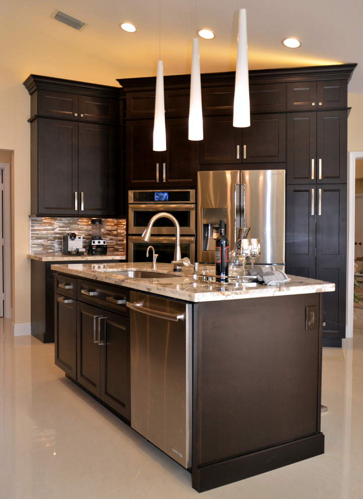 Example of a large transitional l-shaped porcelain tile open concept kitchen design in Miami with an undermount sink, recessed-panel cabinets, dark wood cabinets, granite countertops, multicolored backsplash, mosaic tile backsplash, stainless steel appliances and an island