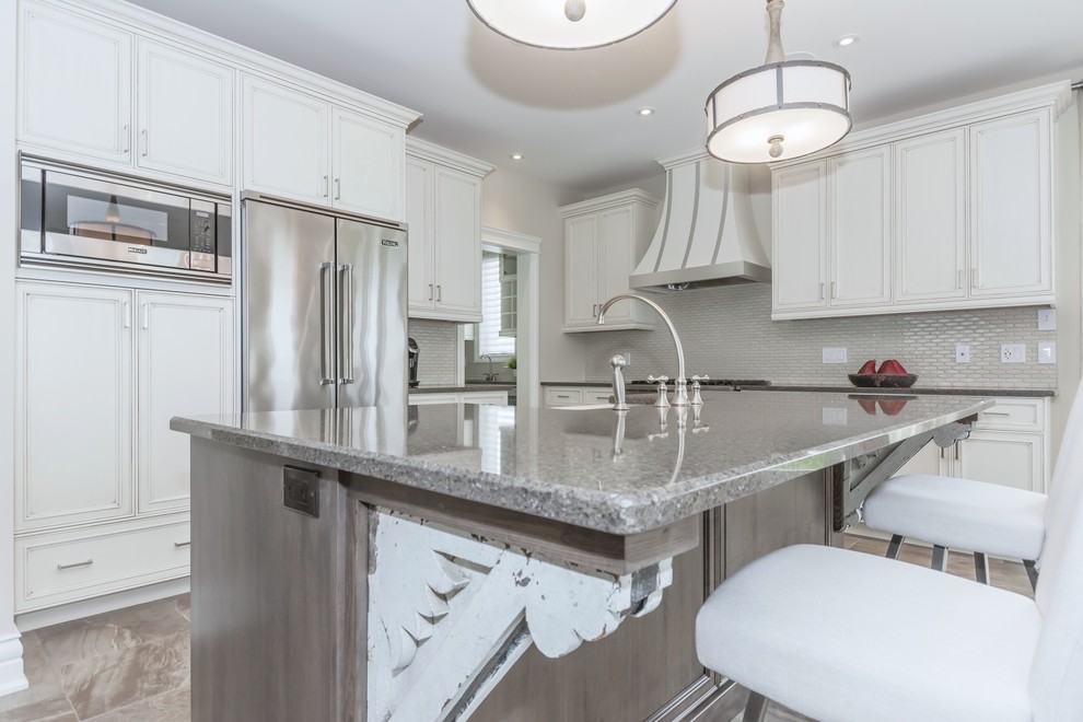 Eat-in kitchen - large transitional porcelain tile eat-in kitchen idea in Toronto with a farmhouse sink, white cabinets, quartz countertops, gray backsplash, ceramic backsplash, stainless steel appliances and an island