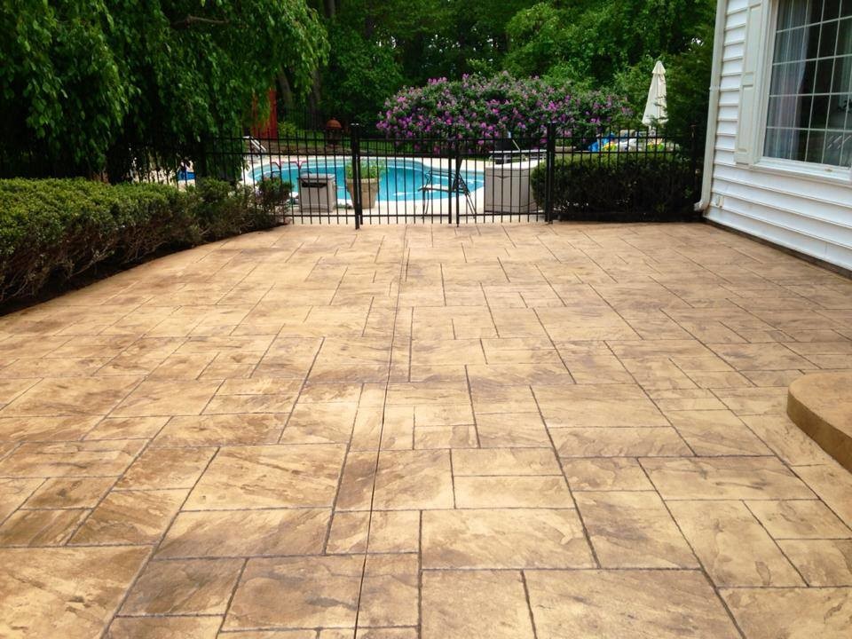 Backyard stamped concrete patio photo in Philadelphia