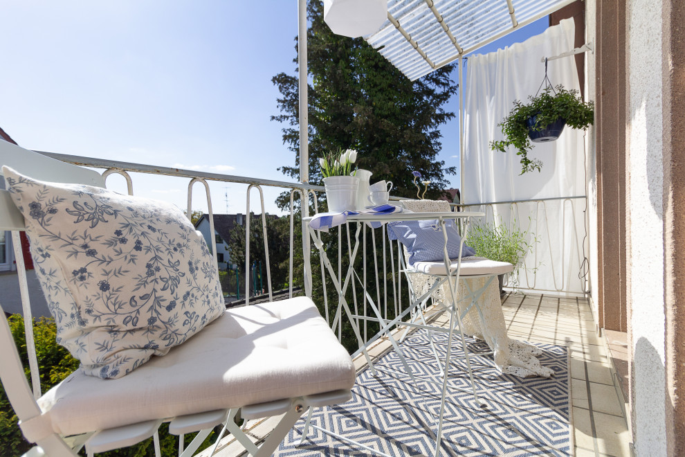 Aménagement d'un petit balcon campagne avec des solutions pour vis-à-vis, une extension de toiture et un garde-corps en métal.