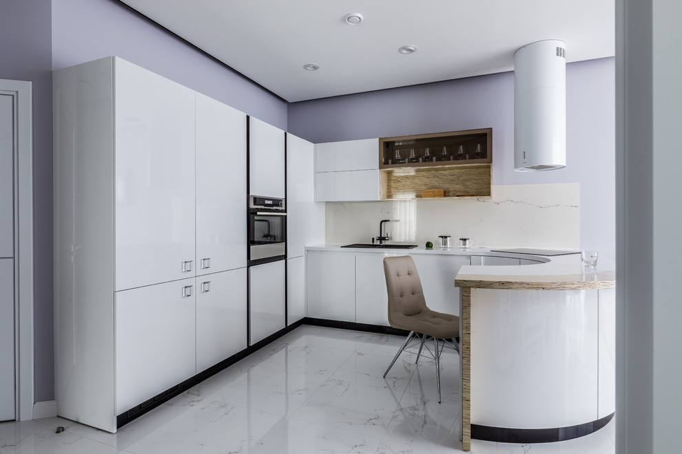 Design ideas for a contemporary u-shaped kitchen in Other with a drop-in sink, flat-panel cabinets, white cabinets, white splashback, a peninsula, white floor, white benchtop and panelled appliances.