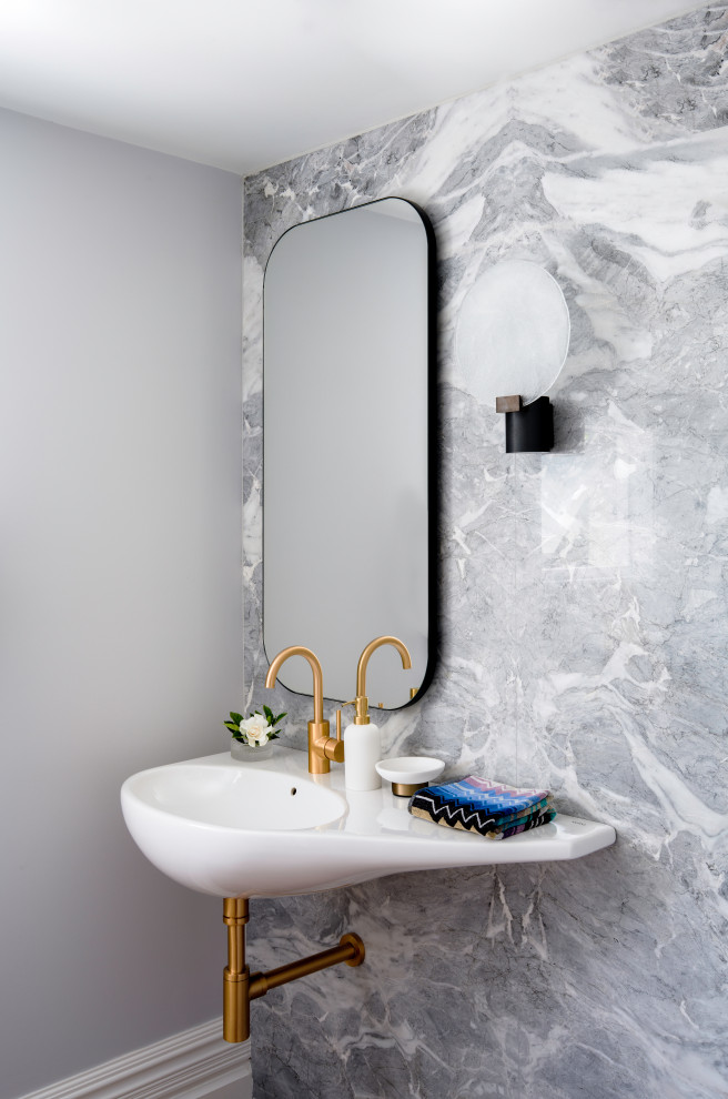 Contemporary powder room in Sydney with gray tile, marble, grey walls, medium hardwood floors, a wall-mount sink and a floating vanity.