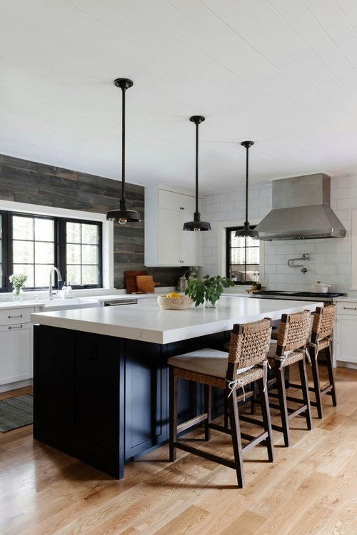 Inspiration for a mid-sized contemporary galley separate kitchen in Seattle with an undermount sink, shaker cabinets, white cabinets, panelled appliances, medium hardwood floors and with island.