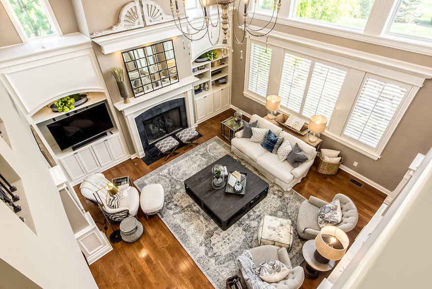 Example of a mid-sized transitional open concept medium tone wood floor living room design in Columbus with beige walls, a standard fireplace, a tile fireplace and a media wall