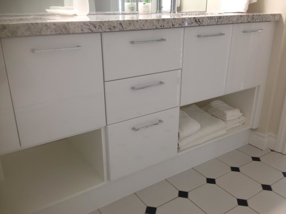 Mid-sized transitional 3/4 porcelain tile bathroom photo with flat-panel cabinets, white cabinets, beige walls, an undermount sink and granite countertops
