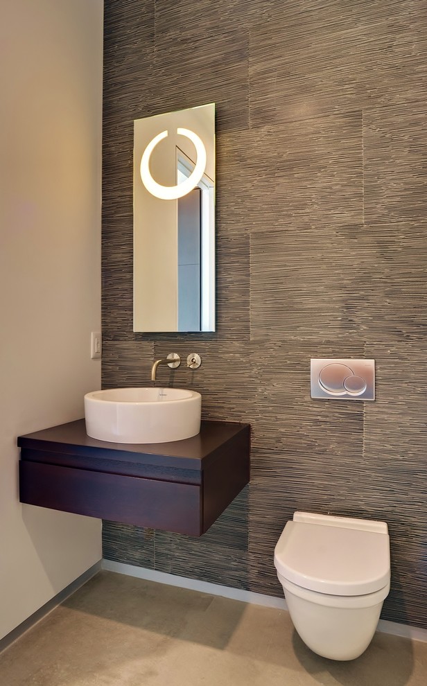 Photo of a contemporary powder room in Miami with a vessel sink and a wall-mount toilet.