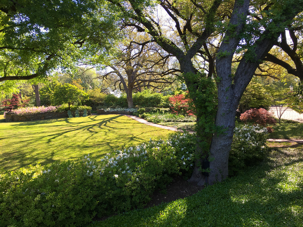 Design ideas for an expansive traditional backyard partial sun formal garden in Dallas with a garden path and brick pavers.