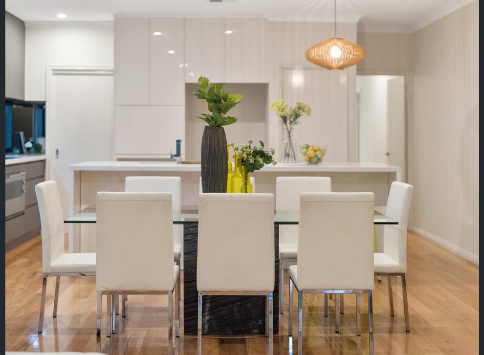 Design ideas for a mid-sized modern open plan dining in Perth with white walls and light hardwood floors.