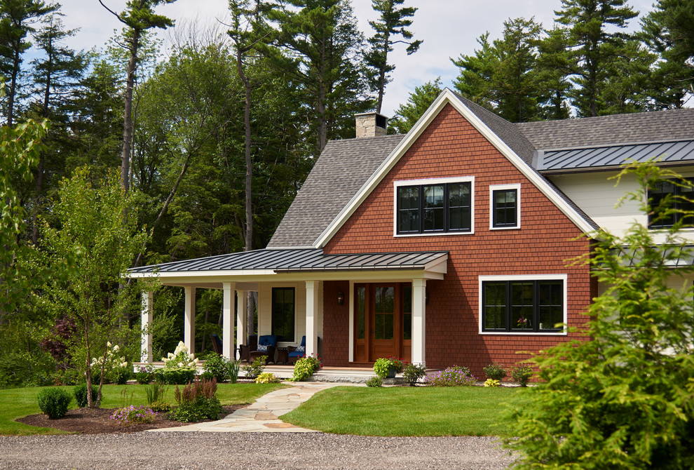 Large country two-storey multi-coloured house exterior in Portland Maine with mixed siding.