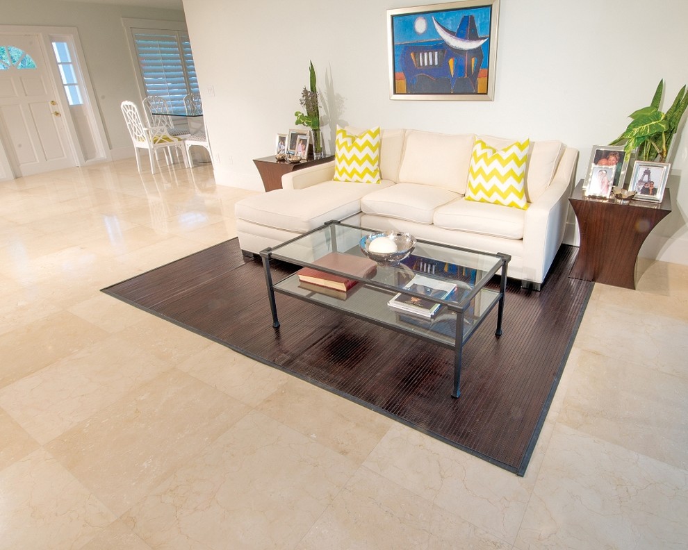 Design ideas for a mid-sized contemporary family room in Miami with grey walls, marble floors, a freestanding tv and beige floor.