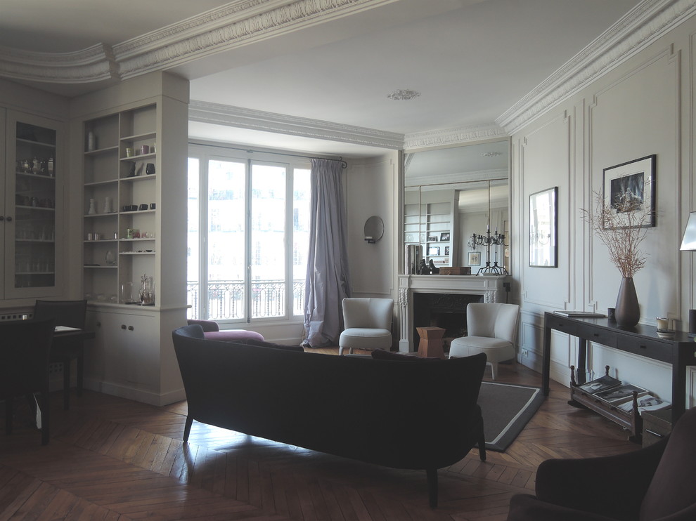 Inspiration for a large transitional formal living room in Paris with grey walls and a stone fireplace surround.
