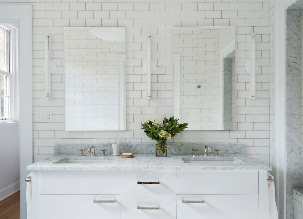 This is an example of a transitional bathroom in Bridgeport with flat-panel cabinets, white cabinets, white tile, subway tile and an undermount sink.